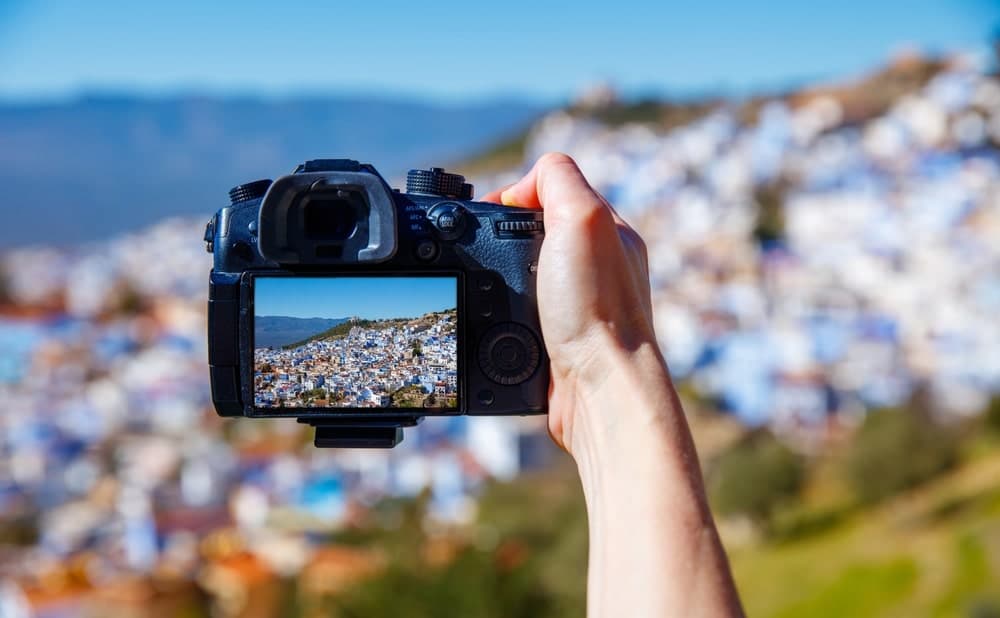 Photographer capturing Chefchaouen's blue streets in the soft morning light