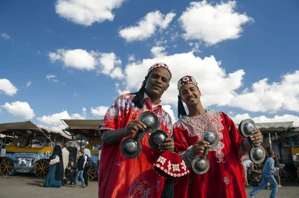 Traditional musicians performing in Jemaa el-Fna square, colorful street life in Marrakech