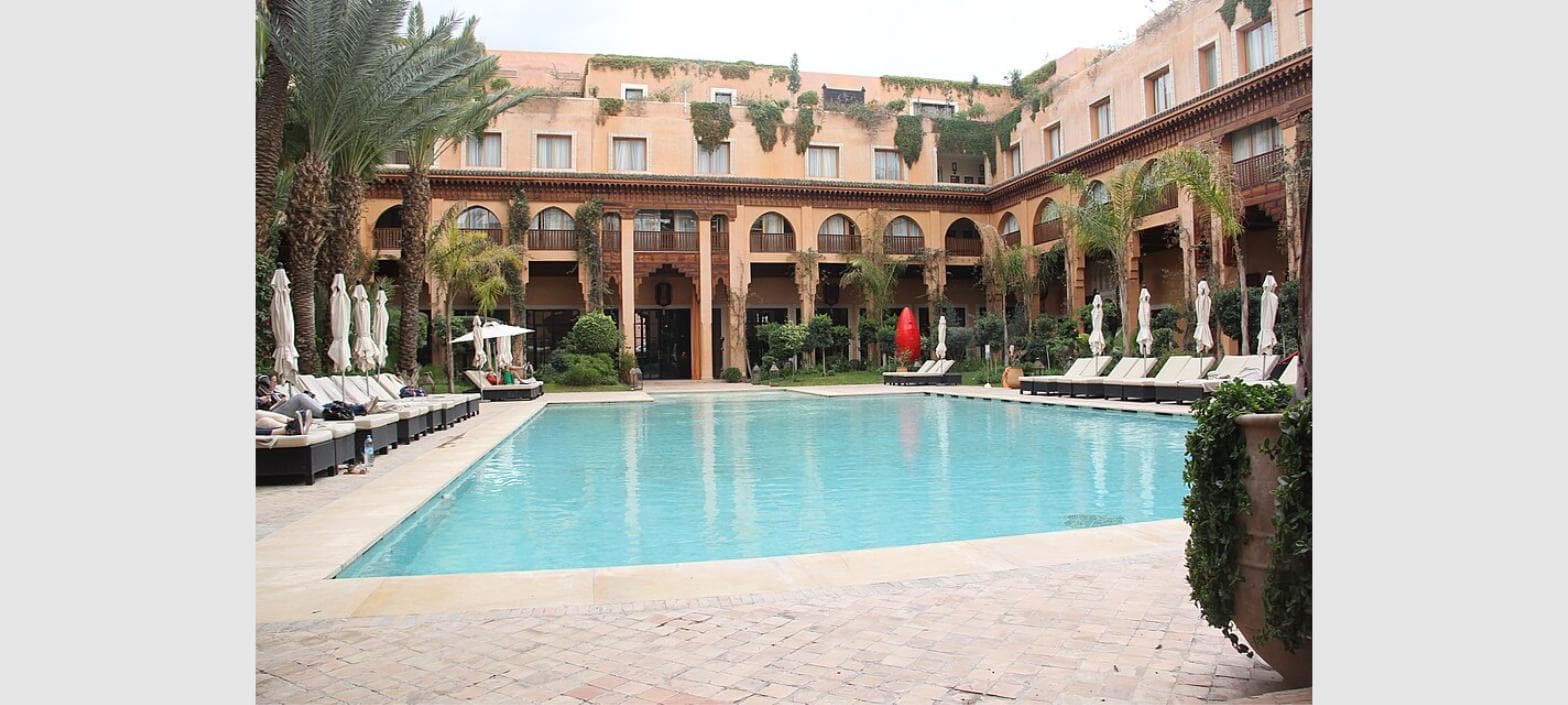 Riad swimming pool courtyard with traditional Moroccan tilework in Marrakech