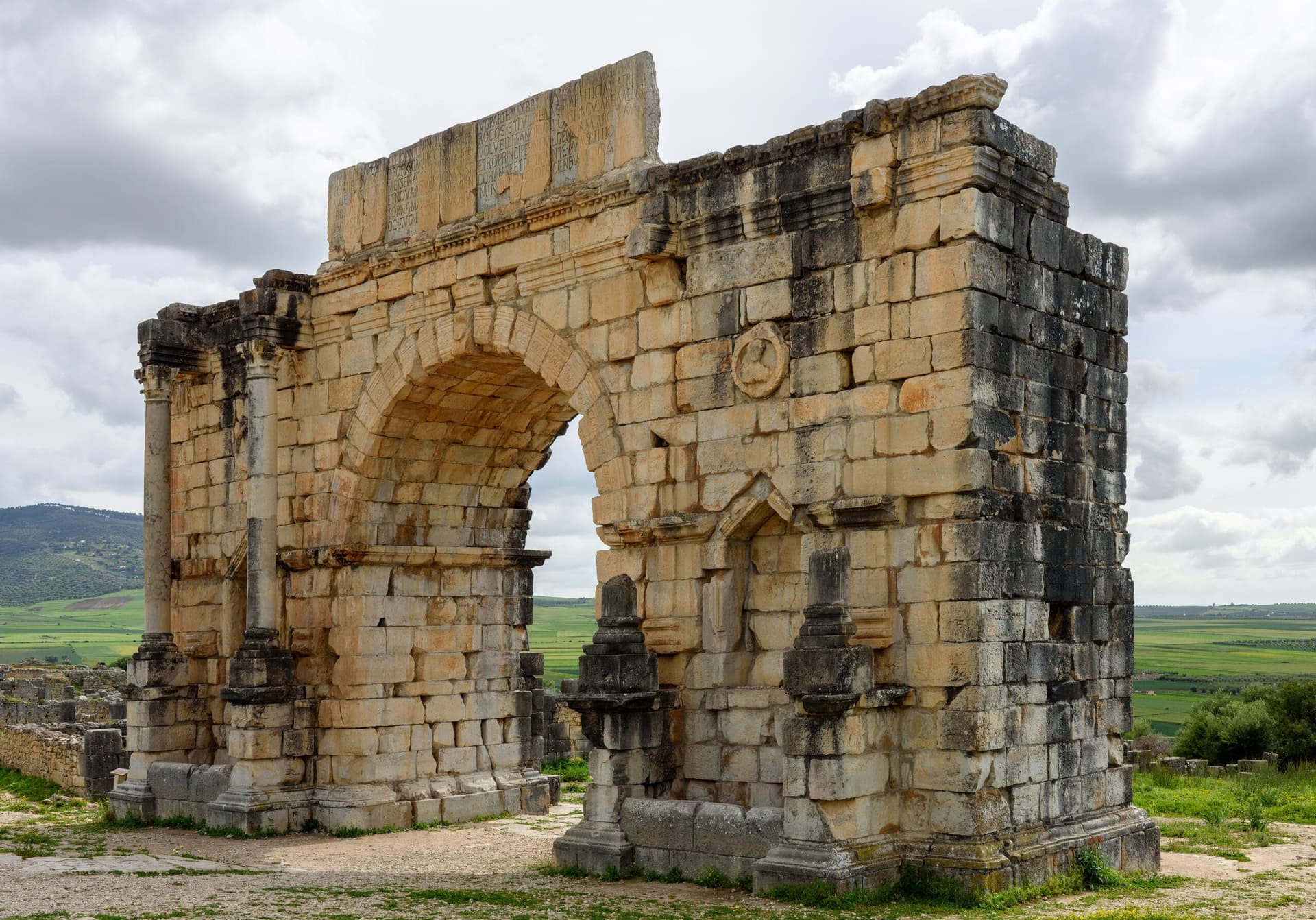 Arch of Caracalla triumphal arch at the Roman ruins of Volubilis, Morocco