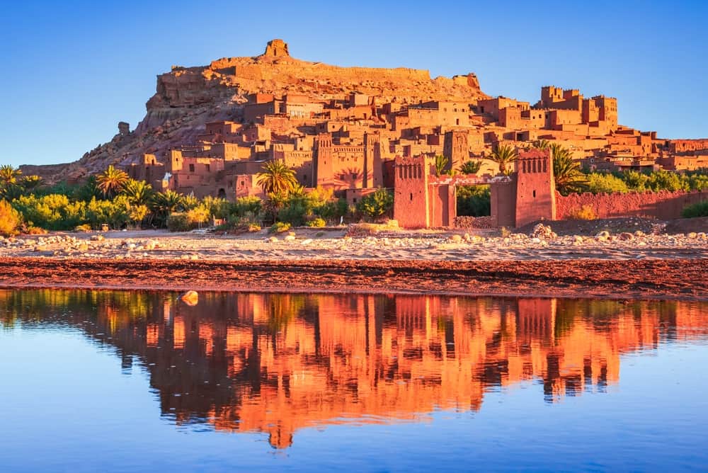 Aït Benhaddou fortified kasbah reflected in the river at golden hour