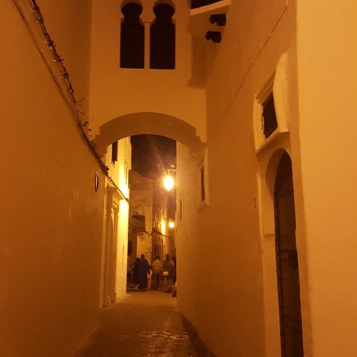 Narrow whitewashed alley in Asilah's old medina, Morocco