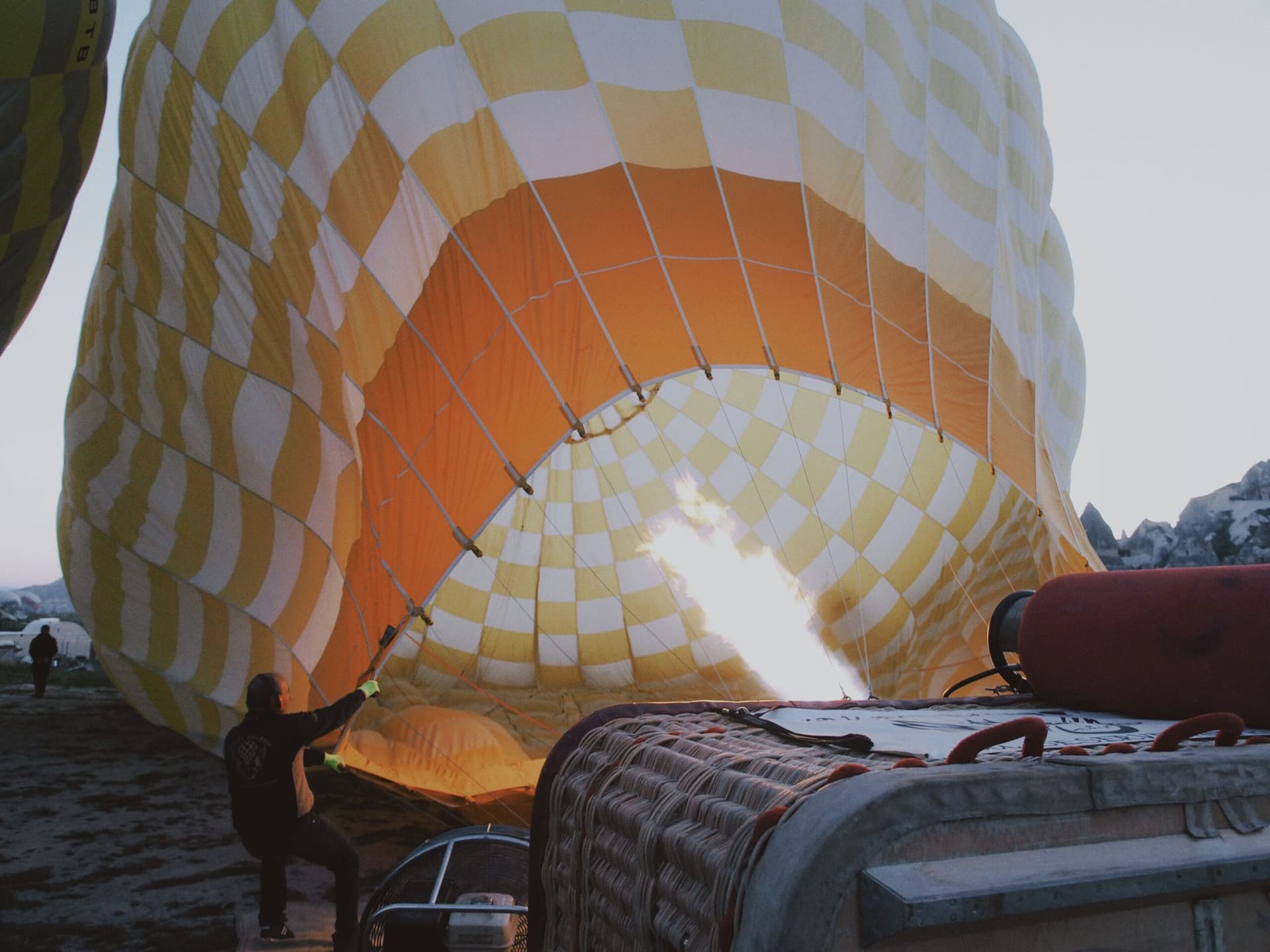 Propane burner flame lighting the dark sky during hot air balloon inflation near Marrakech