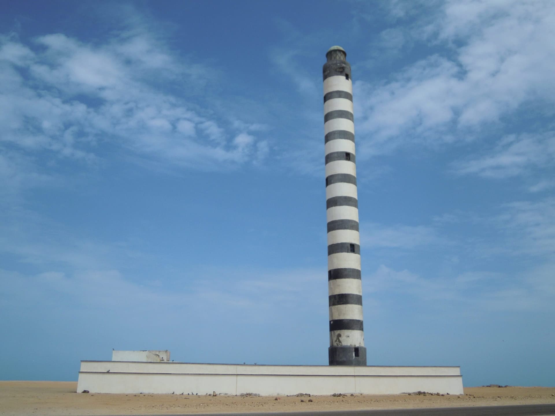 The striped stone lighthouse near Dakhla, Morocco, built in 1916