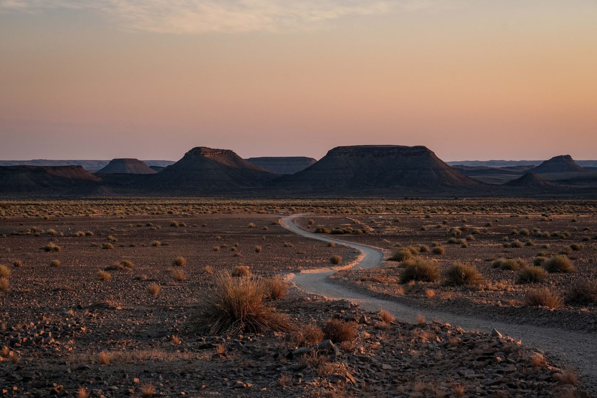 Winding desert road through mesas at sunrise en route to the balloon launch site
