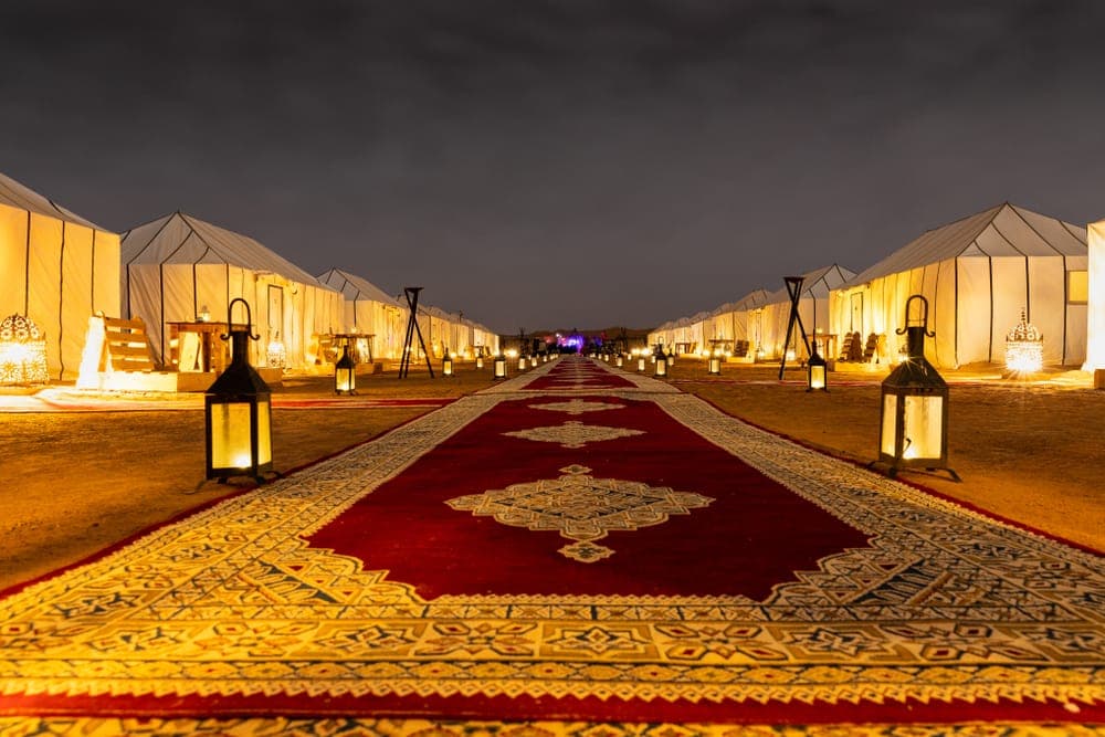 Candlelit walkway of a VIP luxury glamping camp in Merzouga, Erg Chebbi