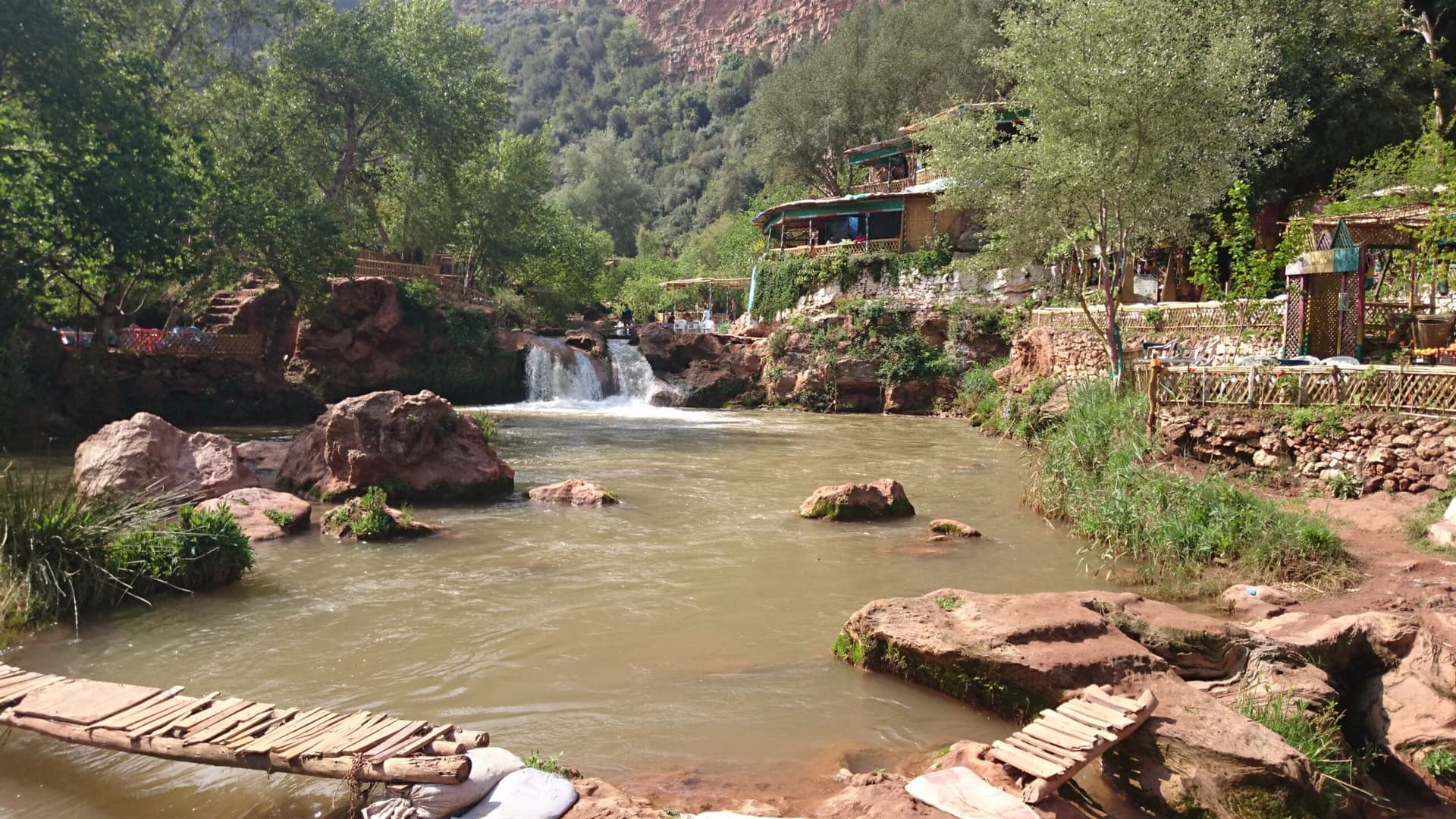 Riverside cafe terraces beside the pools at the foot of Ouzoud Falls