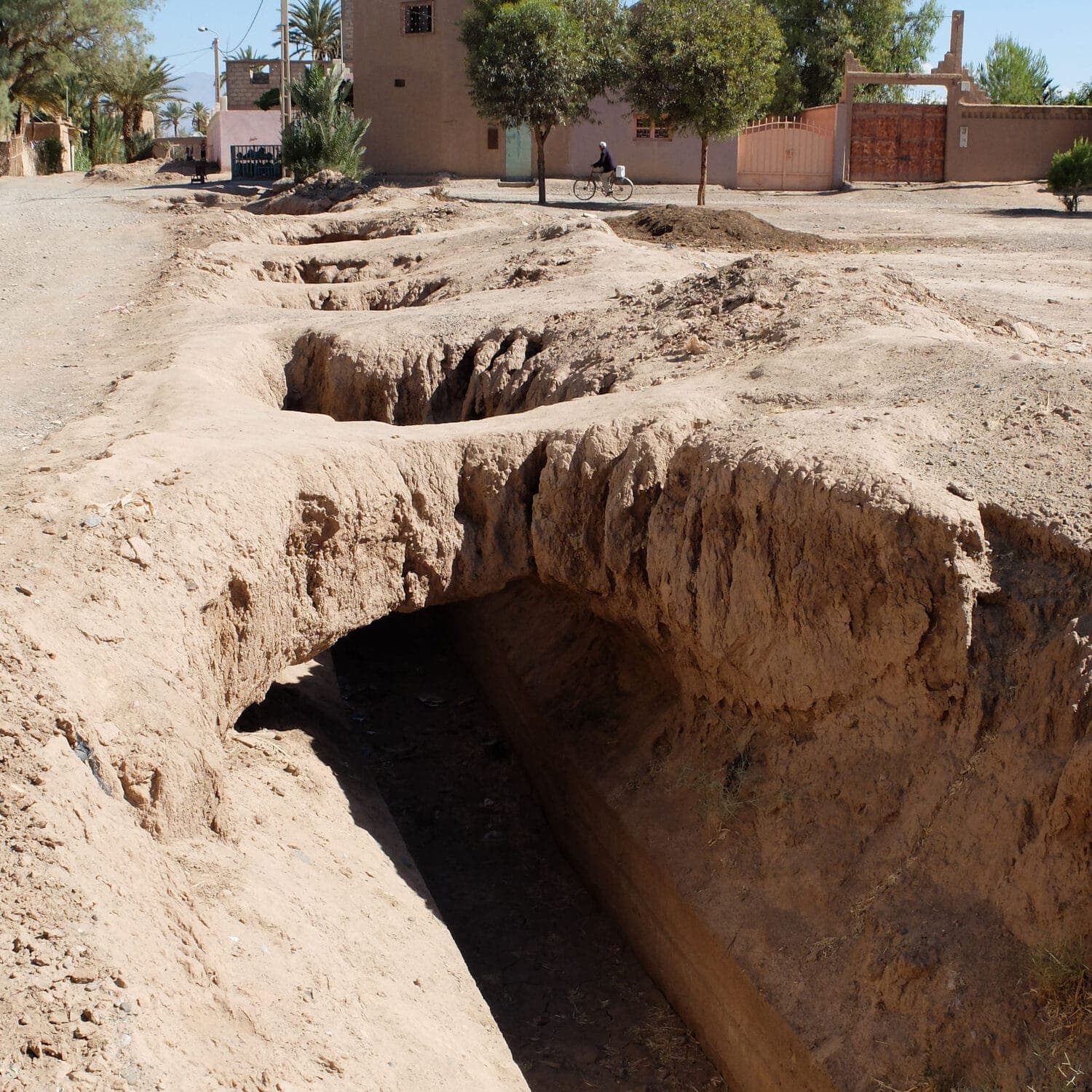 Historic khettara irrigation canal running through the date palm groves of Skoura Oasis, Morocco