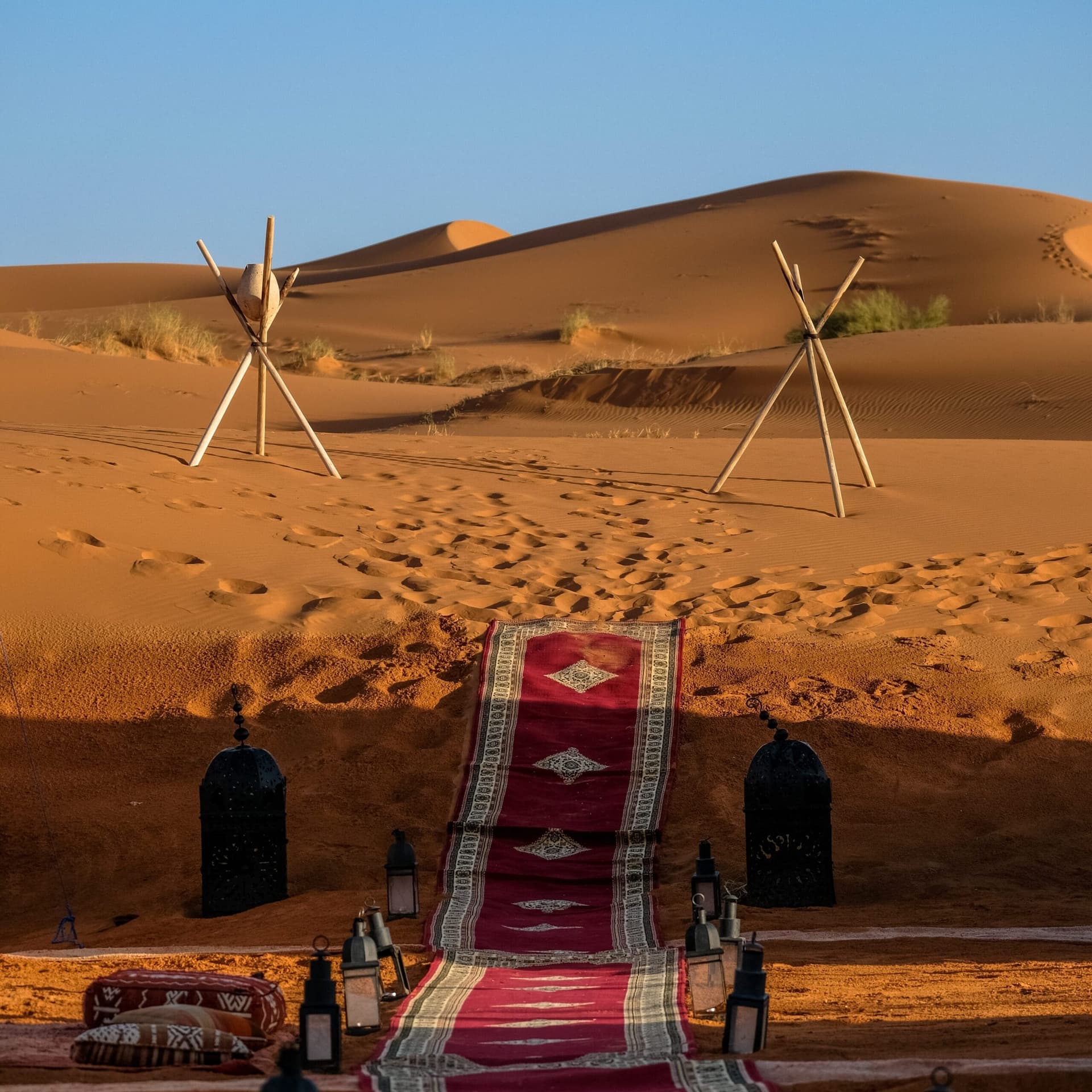 Handwoven red Berber carpet laid out in the desert near Taznakht, Morocco's carpet-weaving capital