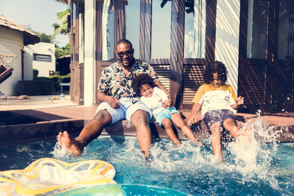 Family playing in a pool