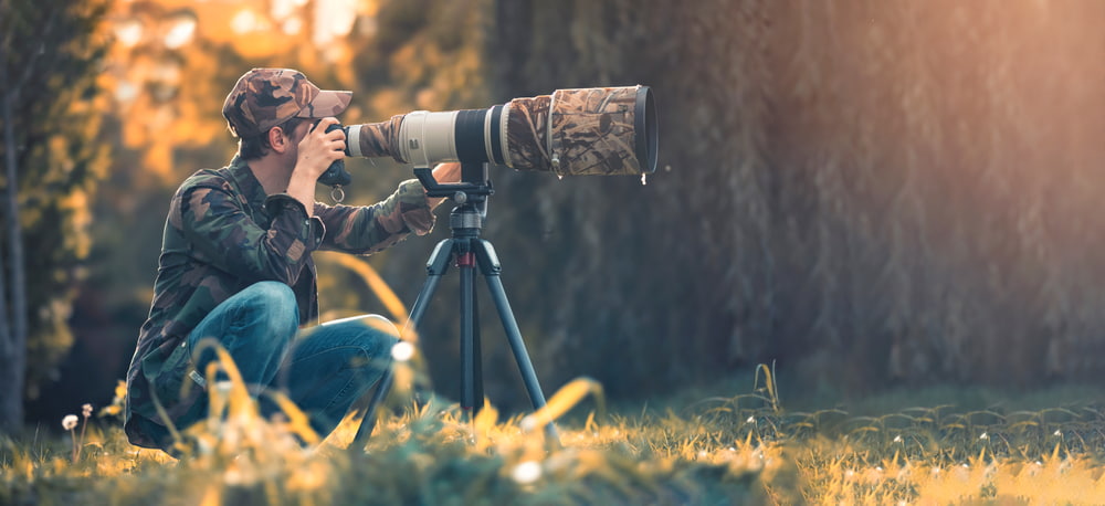 Wildlife Photographer Using Telephoto Lens