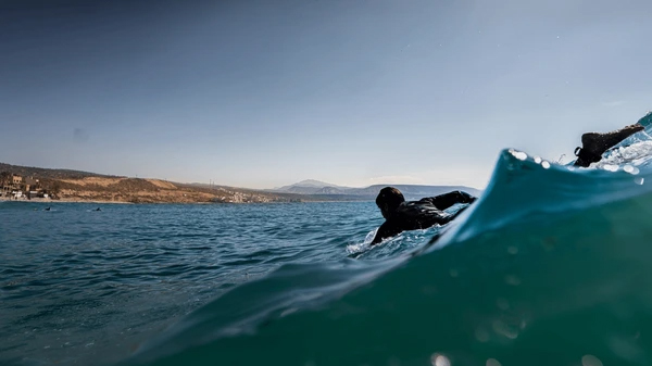 Surfer Paddling For A Wave