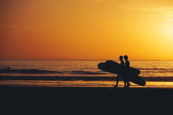 Surfers During Sunset In Taghazout